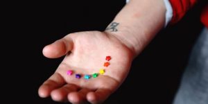 Rainbow colored stars on a person's hand